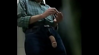 Elderly man with a large penis performs in a bathroom setting