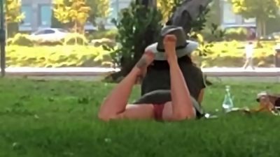 Exhibitionist in the Park spreads legs & dangles soles