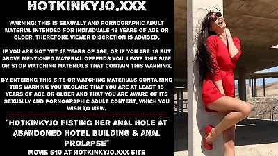 Jo, a sexy woman, performs kinky fisting and anal penetration at an abandoned hotel and experiences a medical complication