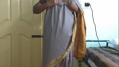 Indian wife Vanitha reveals her shaved pussy and rubs her nipples while pleasuring herself in a gray saree
