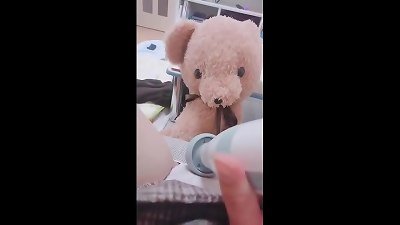 A college girl with a cute bear is masturbating.