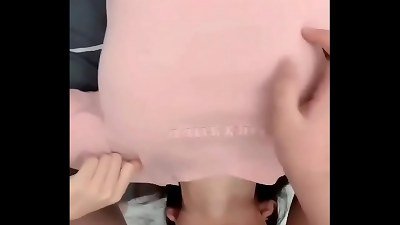 A blonde teenager with large breasts performs a deep oral sex act