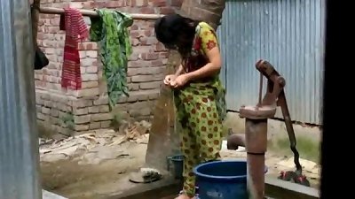 South Asian woman takes a bath outside in the open air, watch the entire clip at zipvale.com