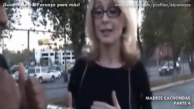 A blonde woman of a certain age enjoys sexual relations with two men with black penises.