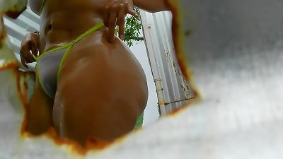 Tan-skinned beauty with a nice ass stuck in a phone booth