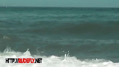 A nudists beach porno video of three girls sitting in the sand